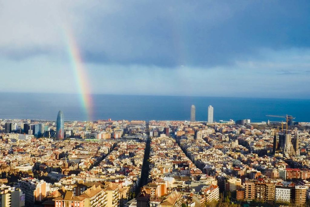 A Sky View Of Barcelona with a beautiful rainbow in the distance