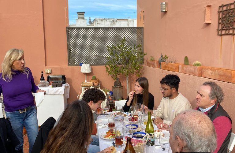 Students and their host family enjoy dinner on a nice patio