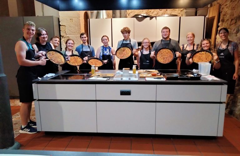 Students cook Paella in a cooking class in Alicante