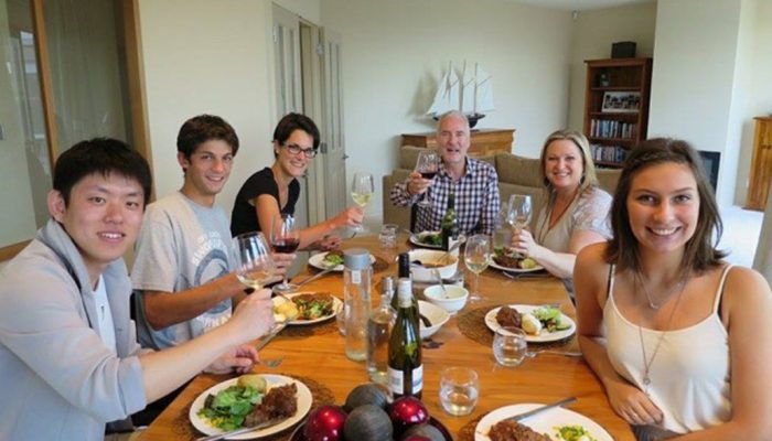 Students enjoy their time eating dinner with host family