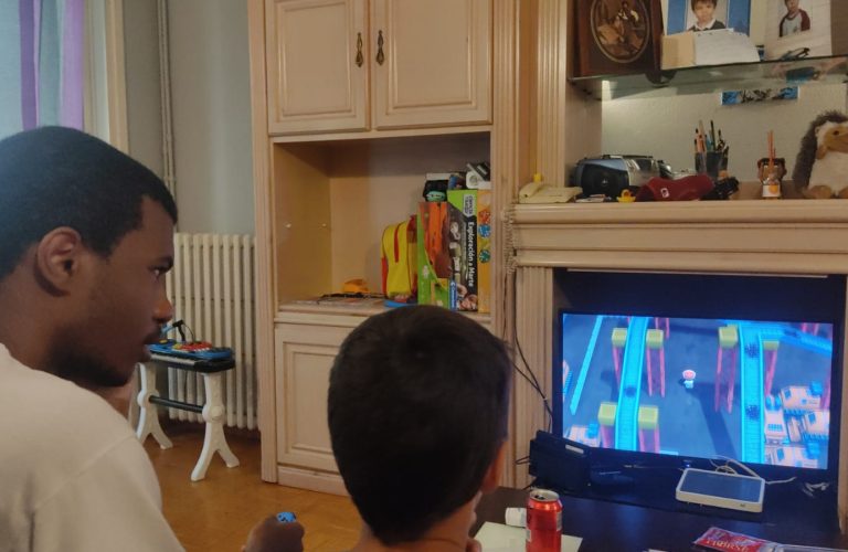 Student learning how to play the local video games with their host brother