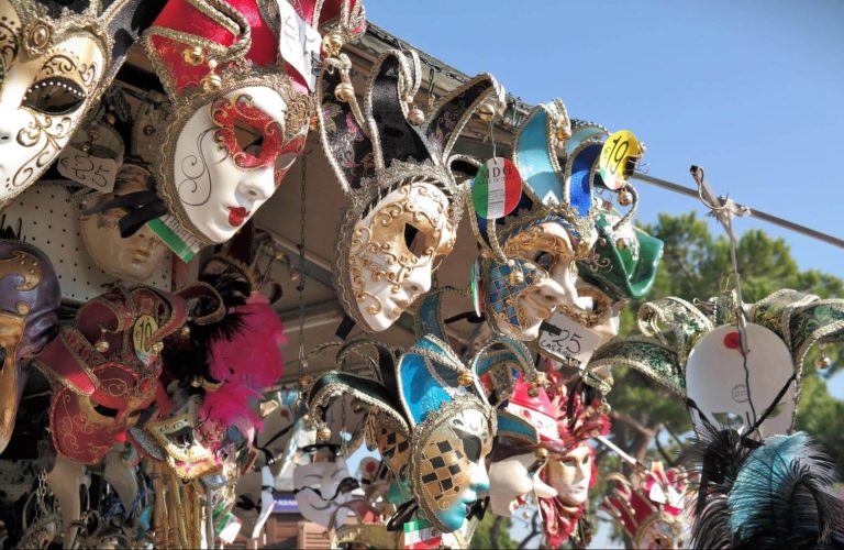 Festival masks hanging from a street vendor stand in Alicante, Spain