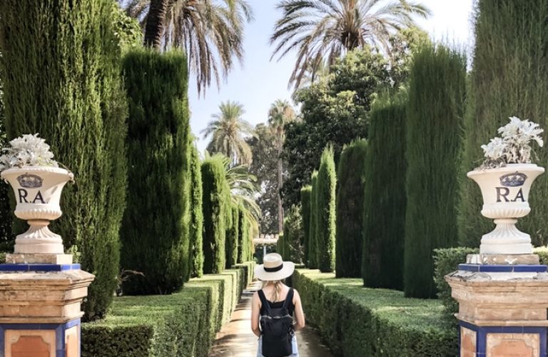 Student enjoys one of many beautiful gardens in seville